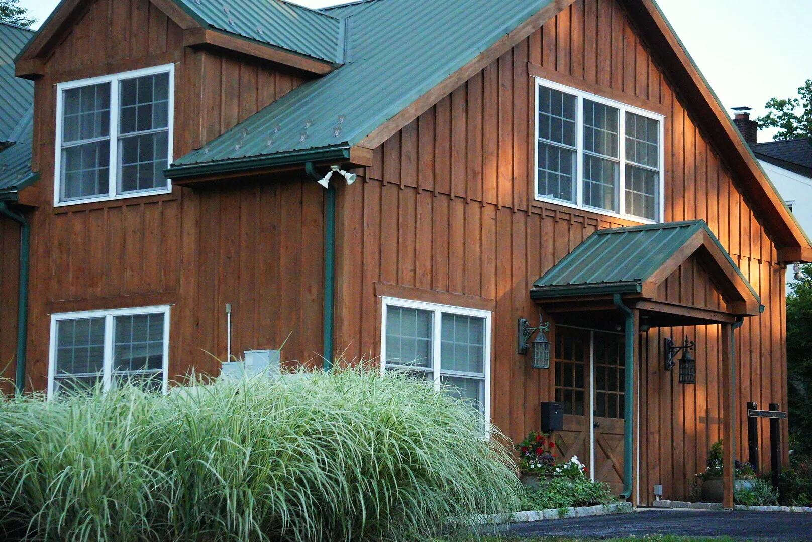 The cedar-sided Chadds Ford office among ornamental grasses at dusk, minutes over the Pennsylvania line