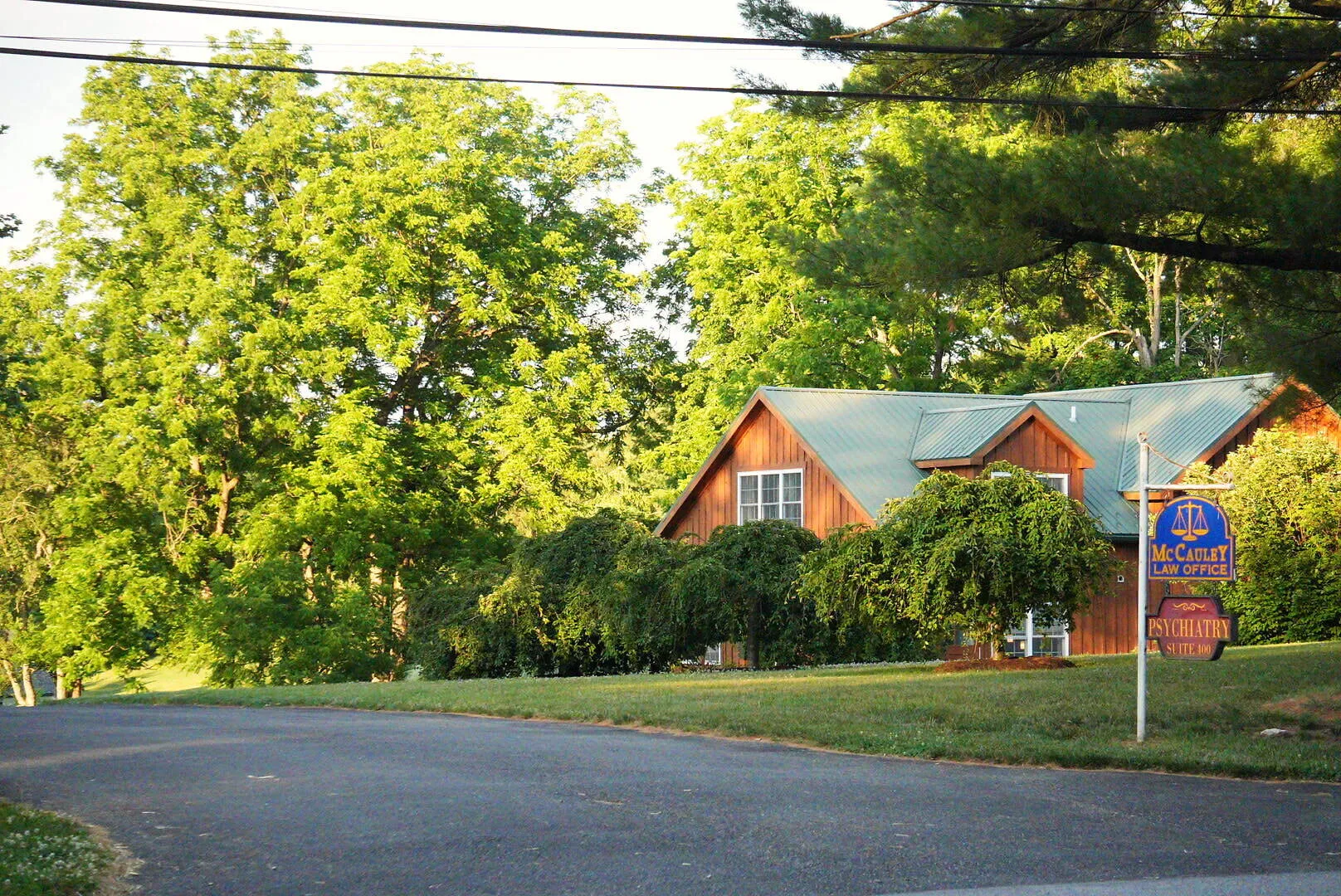The Chadds Ford office set back among mature trees, seen from Kennett Pike